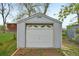 External shot of a white, one car, storage garage with traditional garage door and small brick walkway at 7780 Osceola St, Westminster, CO 80030