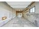 Spacious garage with exposed support beams, concrete floors, and a view to another garage in the backyard at 7780 Osceola St, Westminster, CO 80030