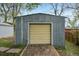 Exterior shot of a small metal storage garage with a yellow door and brick pathway at 7780 Osceola St, Westminster, CO 80030