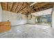 Spacious garage with exposed insulation, concrete floors and an open garage door leading to the backyard at 7780 Osceola St, Westminster, CO 80030
