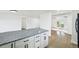 Open concept kitchen features granite countertops and flows into the living and dining areas at 7780 Osceola St, Westminster, CO 80030