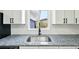 Kitchen sink with granite countertops, stainless steel faucet, and a window view at 7780 Osceola St, Westminster, CO 80030