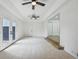 Bright and spacious living room with ceiling fans, steps to a lower level, and backyard access at 7780 Osceola St, Westminster, CO 80030