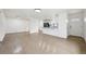 Open-concept living room and kitchen showcasing hardwood floors, modern lighting, and natural light at 7780 Osceola St, Westminster, CO 80030