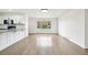 Bright living room featuring hardwood floors, a modern light fixture and a large window at 7780 Osceola St, Westminster, CO 80030