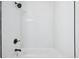 The shower is modern with a bathtub and all white tile at 7780 Osceola St, Westminster, CO 80030