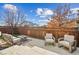 A backyard patio features comfortable seating, a small table, a privacy fence, and a view of the backyard at 376 Dallas St, Denver, CO 80230