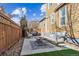 Backyard patio with a seating area, privacy fence, and grill, ideal for outdoor entertaining and relaxation at 376 Dallas St, Denver, CO 80230