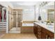 The main bathroom features a glass shower, soaking tub, double sink vanity and walk-in closet at 376 Dallas St, Denver, CO 80230