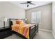 Inviting bedroom with a dark wood bed frame, a ceiling fan, and natural light at 376 Dallas St, Denver, CO 80230