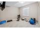 A well-lit exercise room featuring fitness equipment, a window for natural light, and ample space for workouts at 376 Dallas St, Denver, CO 80230