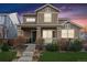 Charming two-story home featuring a welcoming front porch and well-maintained landscaping at 376 Dallas St, Denver, CO 80230