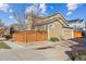 Exterior view of the two-story home with a two-car garage and privacy fence in a residential neighborhood at 376 Dallas St, Denver, CO 80230