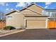 The exterior of the two-car garage with a driveway, a small front yard, and partial landscaping at 376 Dallas St, Denver, CO 80230