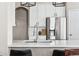 Close-up of kitchen island showcasing white quartz counters and a stainless steel sink at 376 Dallas St, Denver, CO 80230