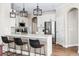 Modern kitchen with stainless steel appliances and a white countertop island at 376 Dallas St, Denver, CO 80230