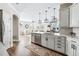 Open-concept kitchen with stainless steel appliances, white cabinets, and a view into the living room at 376 Dallas St, Denver, CO 80230