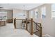 View of the staircase and second floor landing with a decorative wood and metal railing at 376 Dallas St, Denver, CO 80230