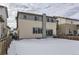 Rear view of two story house with light beige siding and gray accents at 17189 E 103Rd Pl, Commerce City, CO 80022