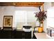 Finished basement area with a window well, office setup, and decorative plant at 1104 Rumbling Sky Pl, Castle Rock, CO 80108