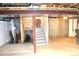 Partially finished basement featuring stairs to upper level and visible utilities at 1104 Rumbling Sky Pl, Castle Rock, CO 80108