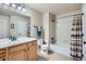 Standard bathroom with light wood cabinets, shower-tub combo, and neutral colors at 1104 Rumbling Sky Pl, Castle Rock, CO 80108