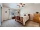 A well-lit bedroom featuring a ceiling fan, large window, and dresser at 1104 Rumbling Sky Pl, Castle Rock, CO 80108