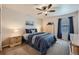 Comfortable bedroom with neutral walls, fan, and blue accents at 1104 Rumbling Sky Pl, Castle Rock, CO 80108