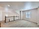 Upstairs bonus room featuring neutral walls, carpet, and stairs with metal railings at 1104 Rumbling Sky Pl, Castle Rock, CO 80108