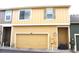 Exterior view of a two-story townhome with a garage, highlighting its facade and design at 1104 Rumbling Sky Pl, Castle Rock, CO 80108