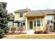 Charming two-story townhome with a covered porch, landscaped yard, and inviting curb appeal at 1104 Rumbling Sky Pl, Castle Rock, CO 80108