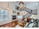 Spacious living room with a fireplace, staircase, and open floor plan at 1104 Rumbling Sky Pl, Castle Rock, CO 80108