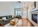 Inviting living room with hardwood floors, fireplace, and a bay window providing natural light at 1104 Rumbling Sky Pl, Castle Rock, CO 80108