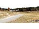 Gravel trail winds through open fields and livestock pens, creating a serene outdoor environment at 1104 Rumbling Sky Pl, Castle Rock, CO 80108
