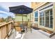 Outdoor patio with table, chairs, and umbrella, perfect for relaxing and entertaining at 1104 Rumbling Sky Pl, Castle Rock, CO 80108