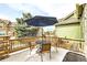 Cozy outdoor patio featuring a table with umbrella, four chairs, and a grill, perfect for enjoying the outdoors at 1104 Rumbling Sky Pl, Castle Rock, CO 80108