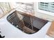 Close-up of a window well with a metal grate, providing natural light to the basement at 1104 Rumbling Sky Pl, Castle Rock, CO 80108