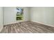 This bedroom features wide windows that provide plenty of natural light and hardwood floors at 6495 E Happy Canyon Rd # 158, Denver, CO 80237
