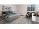 Serene bedroom with a plush bed, modern decor, and a window offering a view of the outdoors at 6495 E Happy Canyon Rd # 158, Denver, CO 80237
