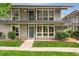 Inviting two-story condo featuring a charming balcony and well-maintained front yard with lush greenery at 6495 E Happy Canyon Rd # 158, Denver, CO 80237