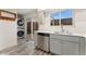 Lovely kitchen with stainless steel appliances, including a dishwasher, and a stacked washer/dryer in the background at 6495 E Happy Canyon Rd # 158, Denver, CO 80237