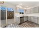 Bright kitchen with stainless steel appliances, gray cabinets, and sliding glass doors to the backyard at 6495 E Happy Canyon Rd # 158, Denver, CO 80237