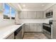 Charming kitchen featuring sleek countertops, stainless appliances, stylish cabinets, and lots of natural light at 6495 E Happy Canyon Rd # 158, Denver, CO 80237
