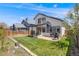 Spacious backyard featuring a shade covering, brick patio, lush lawn, and privacy fence at 8827 Cloverleaf Cir, Parker, CO 80134