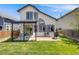 Large backyard featuring a shade covering, brick patio, lush lawn, and privacy fence at 8827 Cloverleaf Cir, Parker, CO 80134