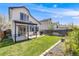 Spacious backyard featuring a shade covering, brick patio, lush lawn, and privacy fence at 8827 Cloverleaf Cir, Parker, CO 80134