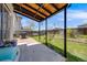 Relaxing backyard area with large shade covering, brick patio, and lush green lawn at 8827 Cloverleaf Cir, Parker, CO 80134