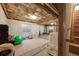 A partially finished basement with exposed ceiling, concrete flooring, window, laundry area and play area at 8827 Cloverleaf Cir, Parker, CO 80134