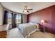 Cozy bedroom with a large window, ceiling fan and a serene and comfortable space at 8827 Cloverleaf Cir, Parker, CO 80134