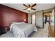 Serene bedroom with a ceiling fan, cozy carpet and easy access to the ensuite bathroom at 8827 Cloverleaf Cir, Parker, CO 80134